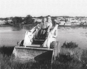 black and white image of two guys in a bobcat at the beginning of Langer Construction