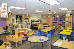 childrens classroom with tables and toys at Tiny Tots Little Tykes